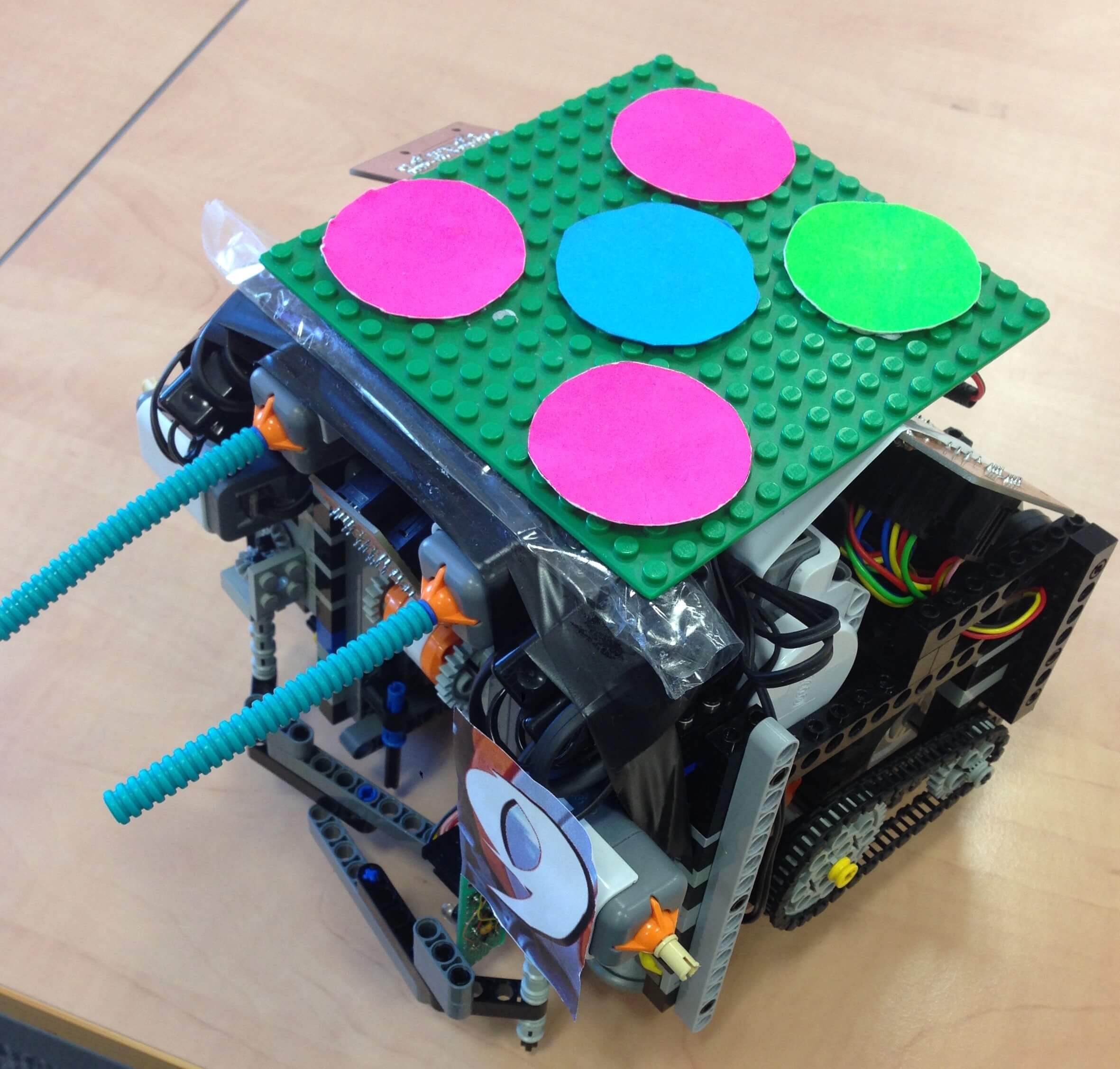 
      Image of the final robot above, including a brightly coloured 'hat' to
      aid camera visibility.
    